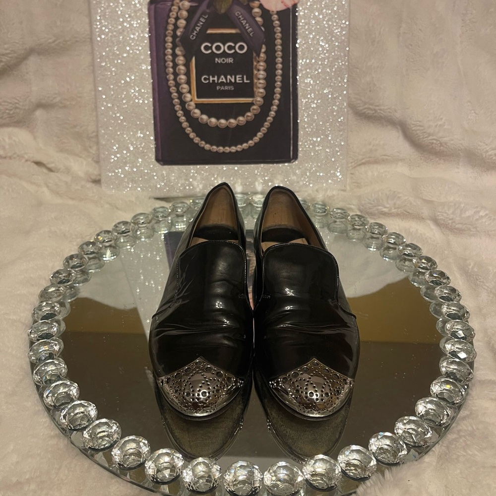 Miu Miu Black and Silver Flats with Elegant Design